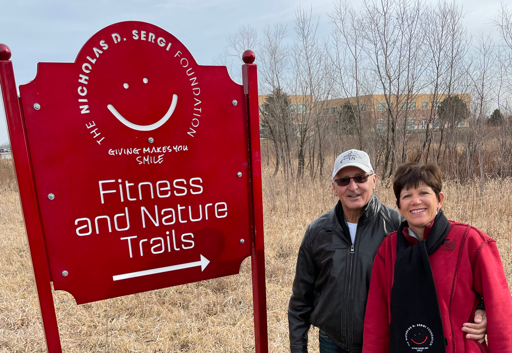 sergi family with fitness nature trail sign